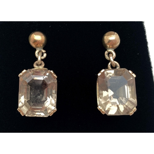 1118 - A pair of princess cut smoked quartz drop earrings in 9ct gold mounts. With decorative pierced work ... 