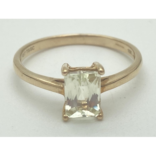 1120 - A 10k yellow gold dress ring set with an prong set emerald cut Serenite gemstone. Ring size Q. Fully... 