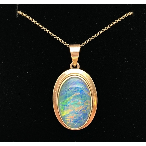 1124 - A 9ct gold and Opal oval shaped pendant on an 18