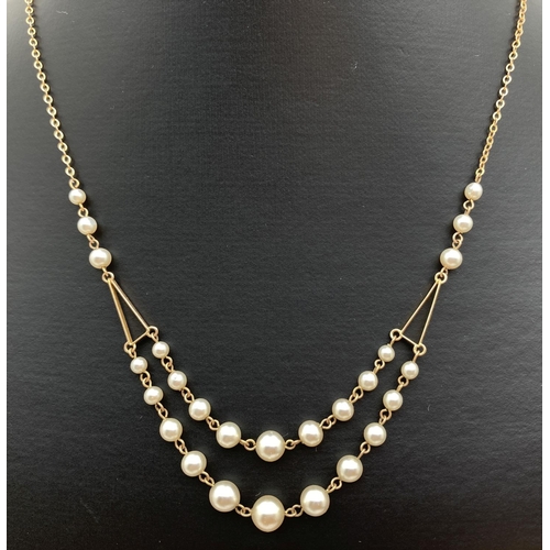 1125 - A vintage 9ct gold and pearl festoon necklace. Hallmarked to chain clasp link (also tests as 9ct). A... 