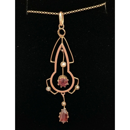 1126 - An Art Nouveau 9ct gold pendant set with garnets and seed pearls. On a 9k 18