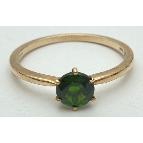 1128 - A 10k yellow gold solitaire dress ring with a tiffany set green Chrome Diopside gemstone. Fully hall... 