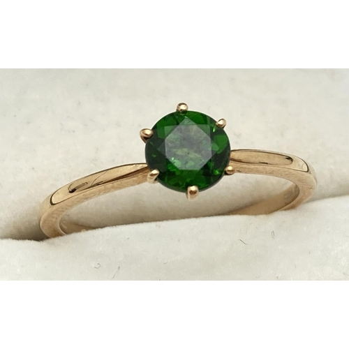 1128 - A 10k yellow gold solitaire dress ring with a tiffany set green Chrome Diopside gemstone. Fully hall... 