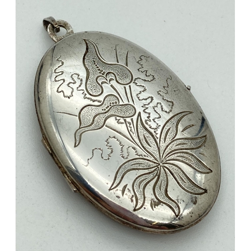 1144 - A large vintage silver locket with engraved arum lily design to front. Fully hallmarked to bale. App... 