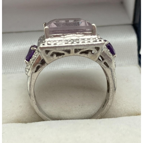 1147 - A chunky 925 silver dress ring set with central square cut Rose De France. With pierced work mount a... 