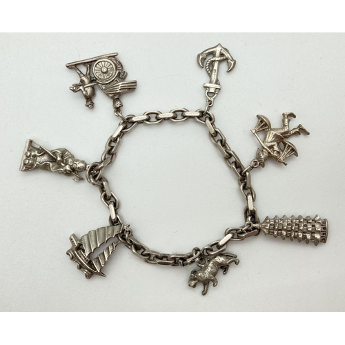 1158 - A vintage sterling silver charm bracelet and charms, with spring clasp. Containing 6 Sterling silver... 