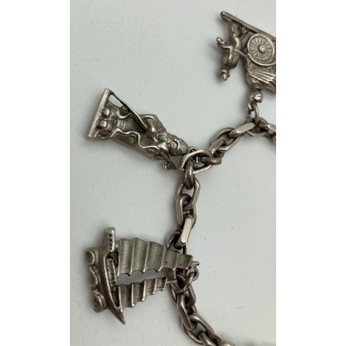 1158 - A vintage sterling silver charm bracelet and charms, with spring clasp. Containing 6 Sterling silver... 