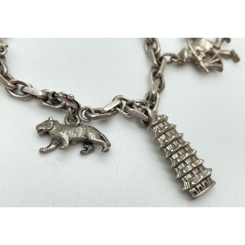 1158 - A vintage sterling silver charm bracelet and charms, with spring clasp. Containing 6 Sterling silver... 