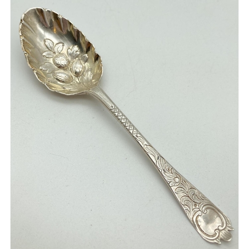 1198 - A Georgian silver dessert spoon with berry decoration to scalloped edge bowl. Engraved detail to bot... 