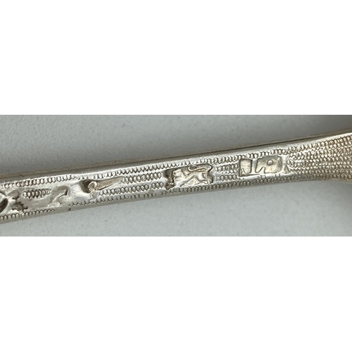 1198 - A Georgian silver dessert spoon with berry decoration to scalloped edge bowl. Engraved detail to bot... 