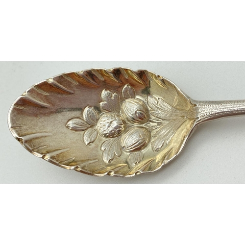 1198 - A Georgian silver dessert spoon with berry decoration to scalloped edge bowl. Engraved detail to bot... 