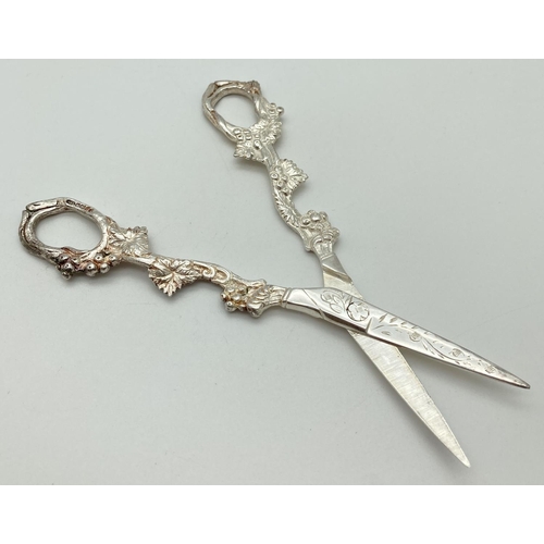 1201 - A pair of solid silver decorative grape scissors with grape vine detail to both sides. Engraved deco... 