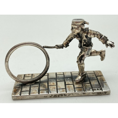 1206 - A small silver figurine of a Victorian child playing Hoop & Stick. Hallmarked to base with 925, make... 