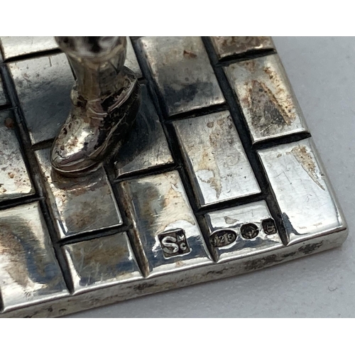 1206 - A small silver figurine of a Victorian child playing Hoop & Stick. Hallmarked to base with 925, make... 