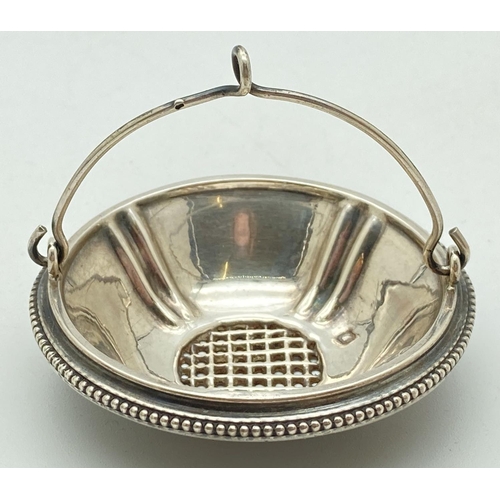 1207 - A 19th century French silver strainer with swing handle and beaded rim. Hallmarked to inner bowl. Ap... 