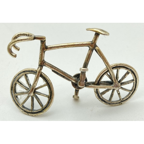 1208 - A Continental silver miniature model of a bicycle, with moving wheels. Stamped 800 to underside. App... 