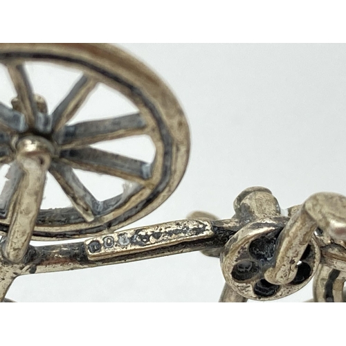 1208 - A Continental silver miniature model of a bicycle, with moving wheels. Stamped 800 to underside. App... 