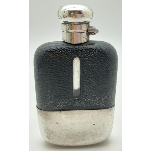 1209 - A vintage glass hip flask with silver plated detachable cup and leather bound top. Cork lined silver... 