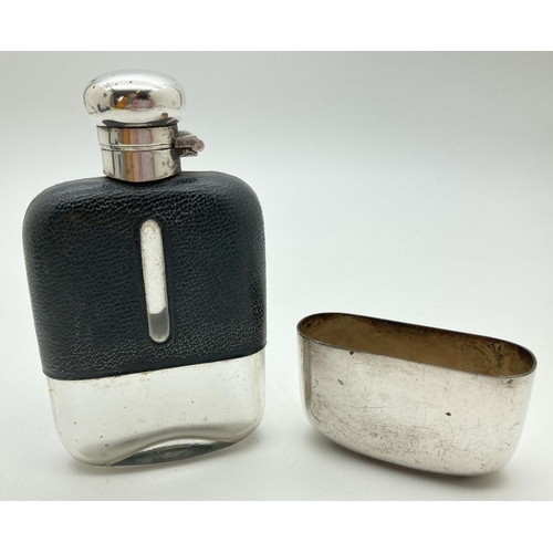 1209 - A vintage glass hip flask with silver plated detachable cup and leather bound top. Cork lined silver... 