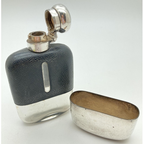 1209 - A vintage glass hip flask with silver plated detachable cup and leather bound top. Cork lined silver... 