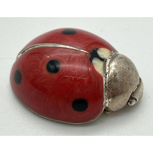 1218 - A small 925 silver ladybird with enamelled body in red, black & cream. Stamped to underside. Approx.... 