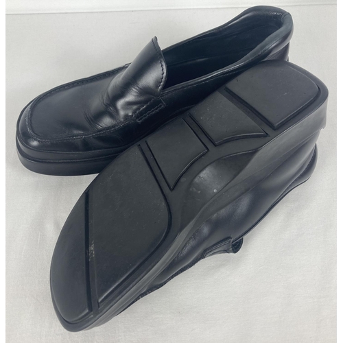 51 - A pair of black leather chunky soled shoes by Prada. Size 7, in worn condition. Complete with Prada ... 