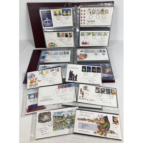 65 - Approx. 160 assorted First Day Covers dating from the late 1980's to early 2000's. In 2 burgundy Roy... 