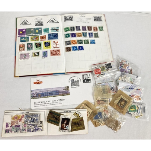 68 - A vintage stamp album of assorted mid century world stamps together with a quantity of loose stamps,... 