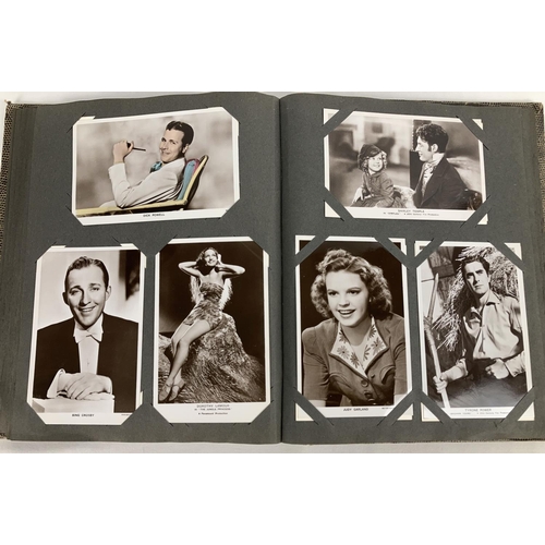 186 - A vintage postcard album containing a collection of film studio black and white and coloured photogr... 