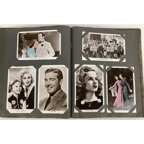 186 - A vintage postcard album containing a collection of film studio black and white and coloured photogr... 