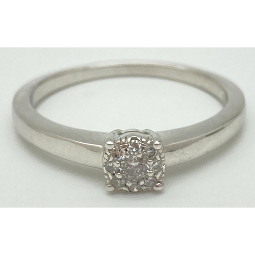 1049 - A 925 silver and diamond cluster ring, complete with jewellery report. Approx 0.1 carats of round br... 