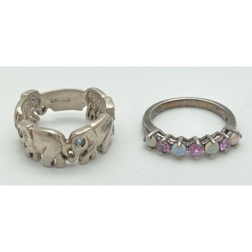 1065 - 2 silver dress rings. A elephant band style ring, each elephants eye is set with a small pale blue s... 