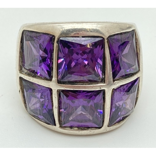 1077 - A chunky 925 silver dress ring set with 6 square cut amethyst stones. Ring size N, band width approx... 