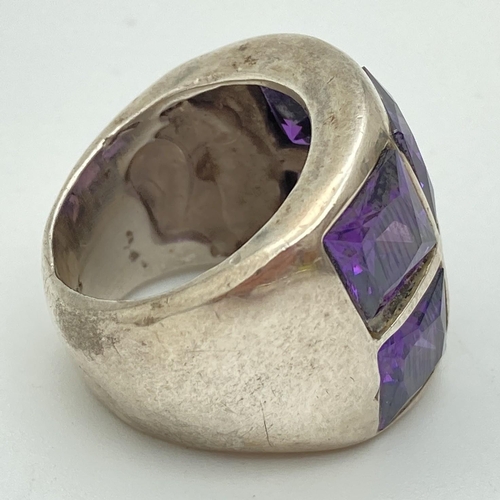 1077 - A chunky 925 silver dress ring set with 6 square cut amethyst stones. Ring size N, band width approx... 