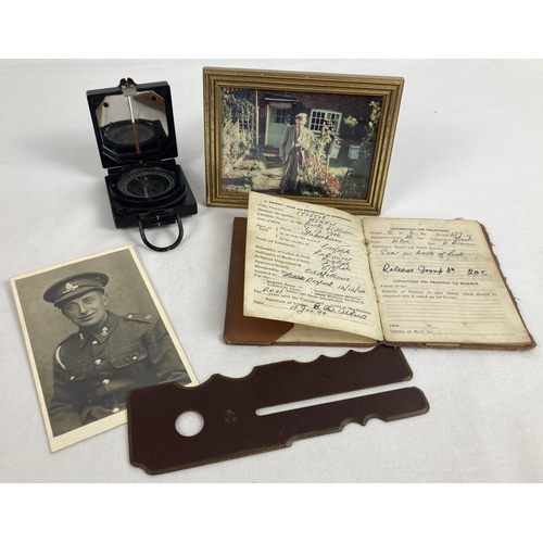 1251 - A small collection of WWII era army memorabilia. A bakelite cased folding magnetic marching compass ... 