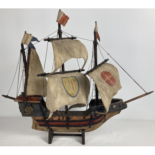 1339 - A vintage 1930's wooden model ship with painted leather details and sails. Engraved brass presentati... 