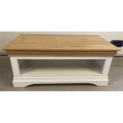 1436 - A modern cream painted coffee table with natural finish pine top. With undershelf and shaped base. A... 