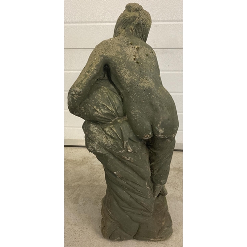 1410 - A concrete garden statue of  a woman pouring water from an urn. Approx. 84cm tall.