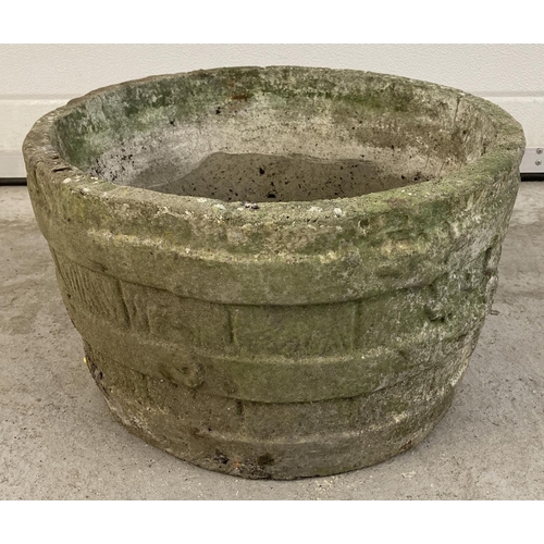 1414 - A vintage concrete garden planter in the form of a wooden barrel. Approx. 26cm tall x 44cm diameter.