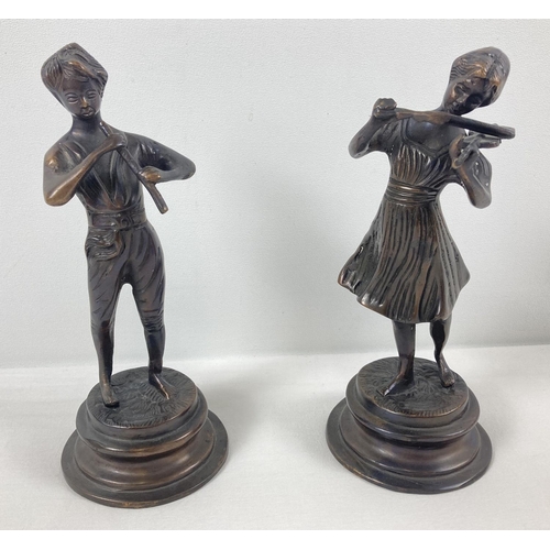 1239 - A pair of vintage bronzed effect brass figures playing musical instruments. On circular pedestal bas... 