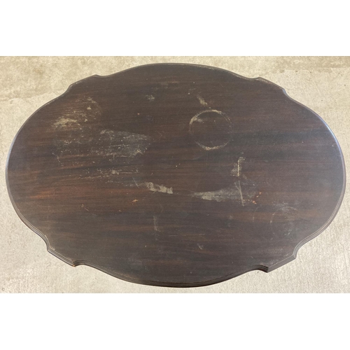 1448 - An Edwardian dark wood oval topped occasional table with straight legs, bun feet and shaped top. Som... 