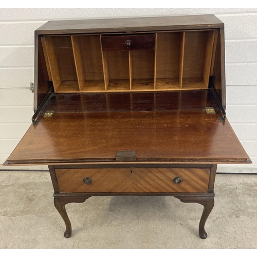 1452 - A vintage 3 drawer bureau with brass hooped handles and escutcheons. Drop down writing platform with... 