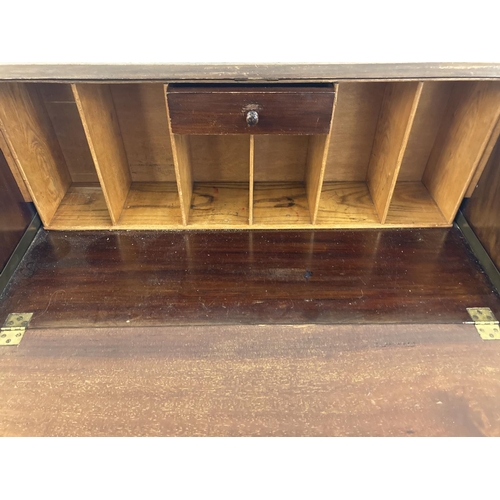 1452 - A vintage 3 drawer bureau with brass hooped handles and escutcheons. Drop down writing platform with... 