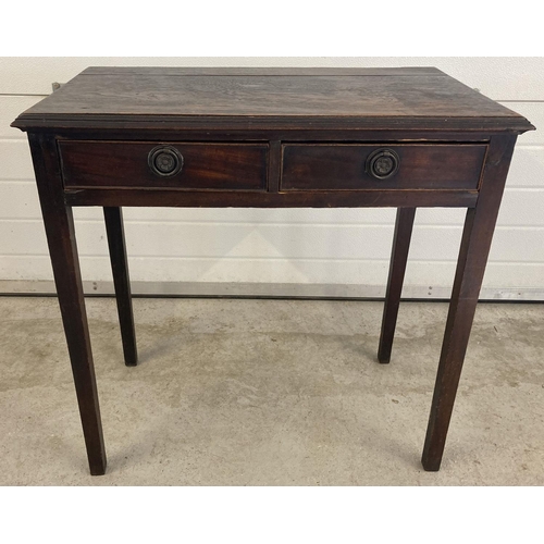 1453 - A vintage dark oak 2 drawer hall/console table with brass hooped handles and straight legs. Approx. ... 