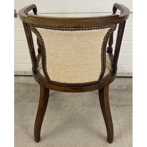 1455 - An Edwardian curve backed tub chair with tapered front legs and spade feet. Reupholstered with cream... 