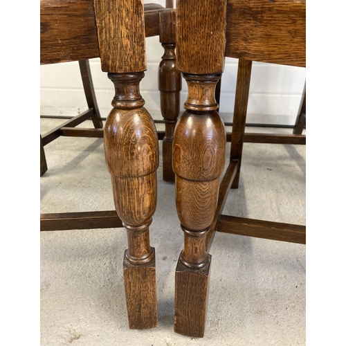 1456 - A set of 4 dark oak early 20th century dining chairs with slatted backs, carved detail & acorn desig... 