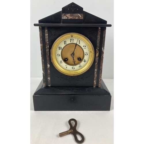 1253 - A Victorian black slate mantel clock with marble inlaid detail and enamelled face. Glass missing. Co... 