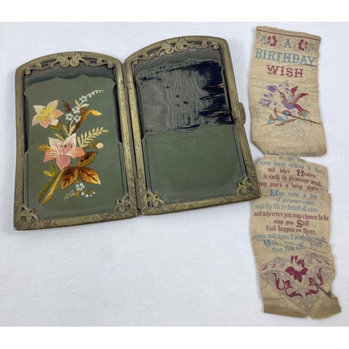 1360 - An Edwardian leather needle case wallet with decorative brass frame and embroidered floral decoratio... 