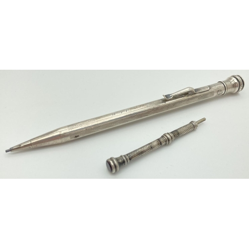 1195 - A silver filled propelling pencil by Eversharp with engine turned decoration and initials 