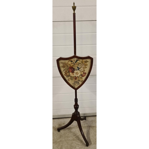 1464 - An antique Regency mahogany pole screen with embroidered felt floral panel in a shield shaped frame.... 